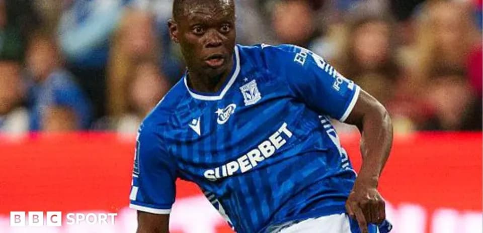 Player in blue jersey preparing to kick ball