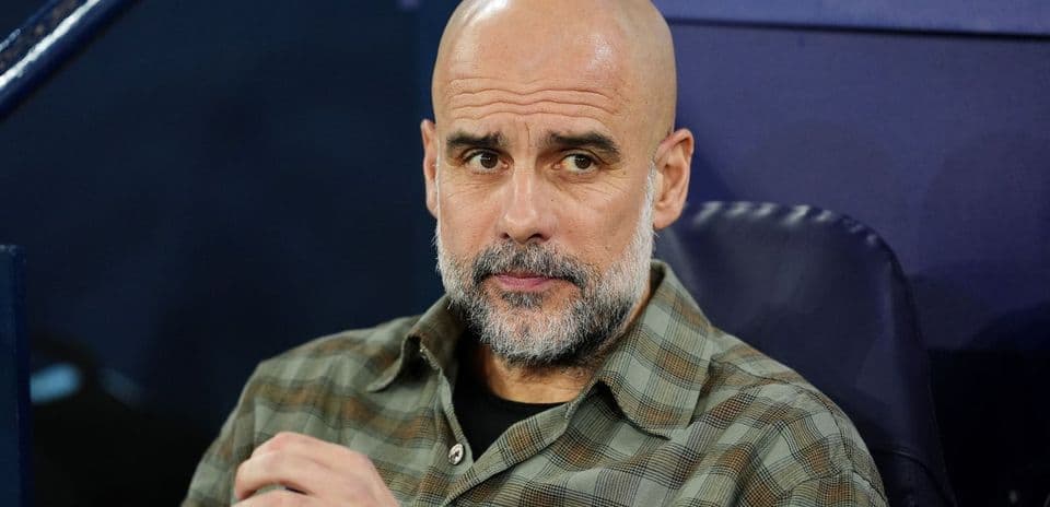 Coach sitting on bench during match preparations