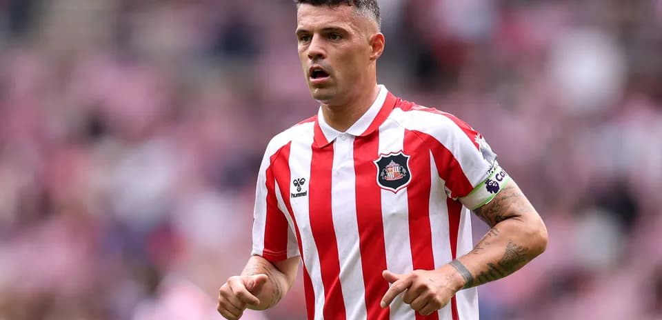 Player in red and white striped jersey on field