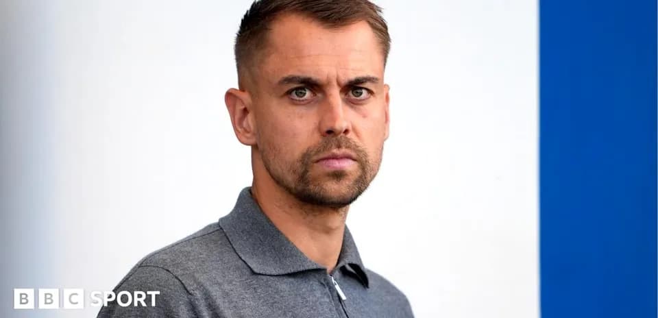 Man with short hair in a gray polo shirt