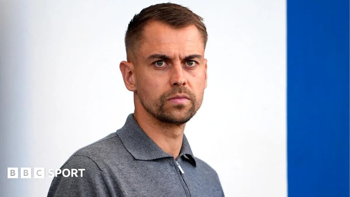 Man with short hair in a gray polo shirt