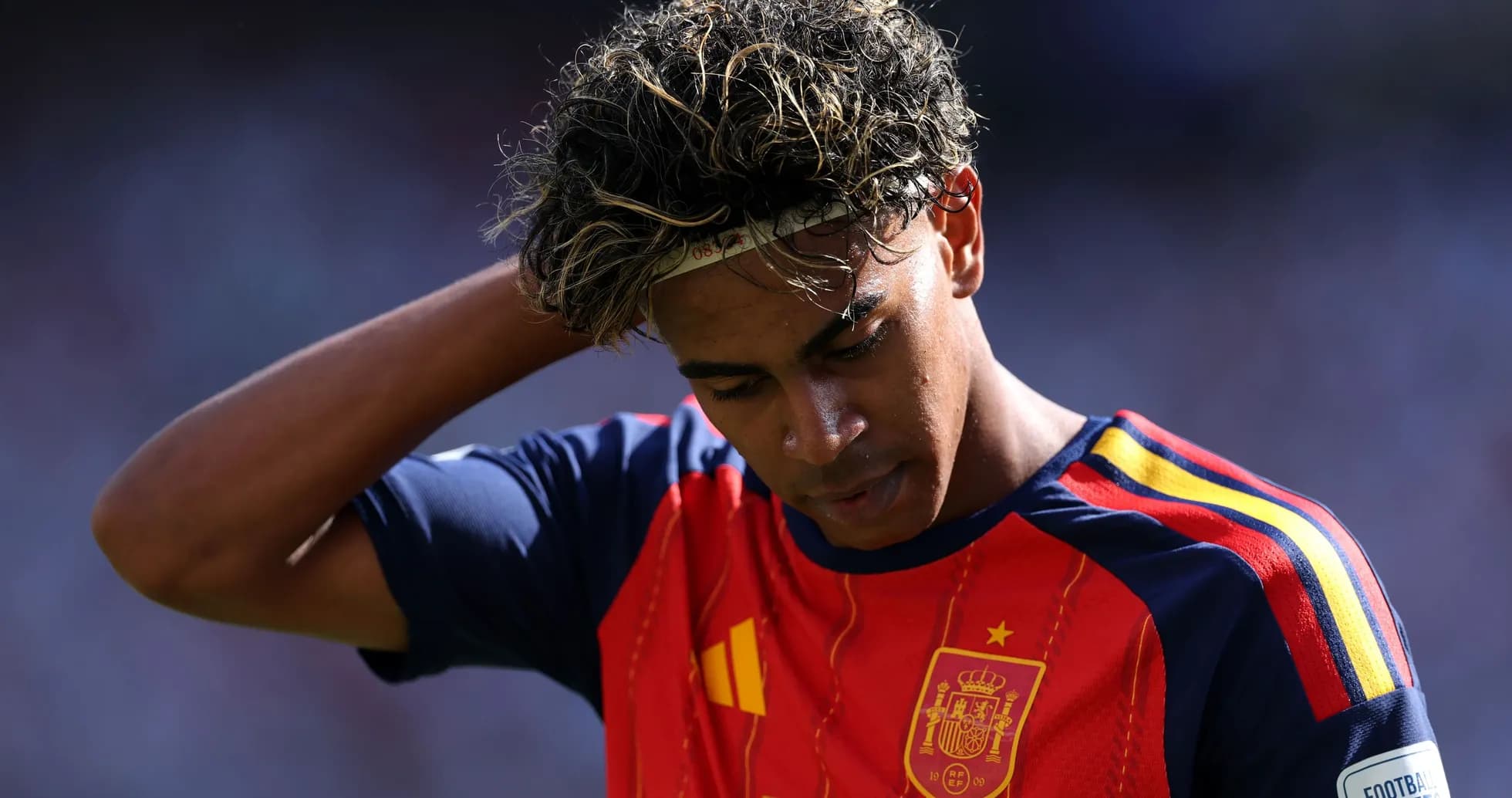 Player in Spain jersey looking down on field
