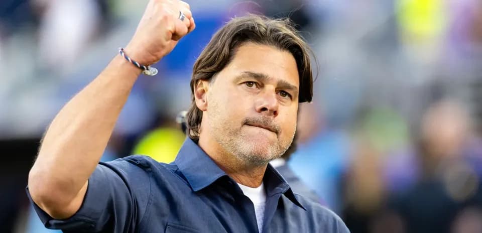 Coach raising fist in celebration on the sidelines