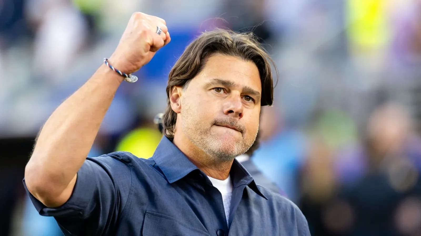 Coach raising fist in celebration on the sidelines