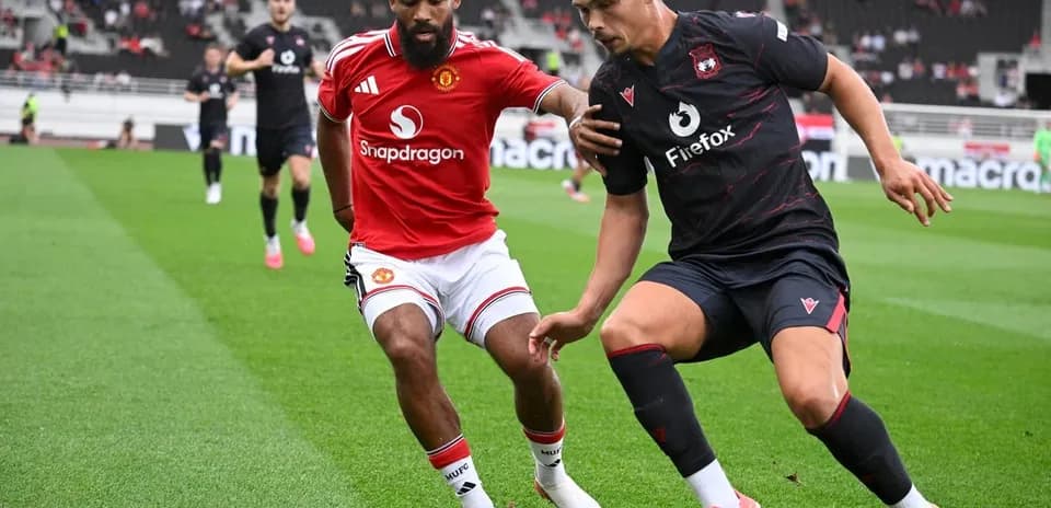 Two players competing for the ball on field
