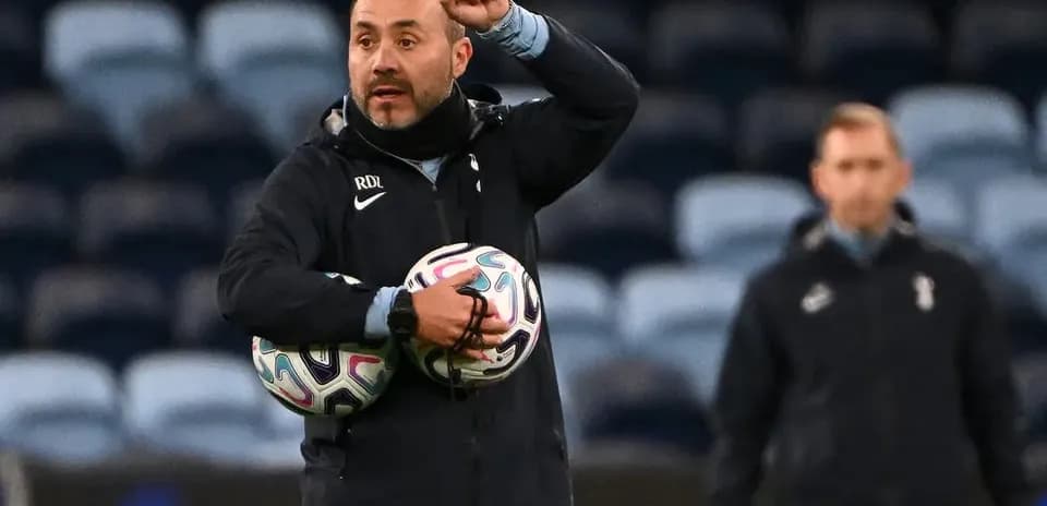 Coach giving instructions while holding soccer balls