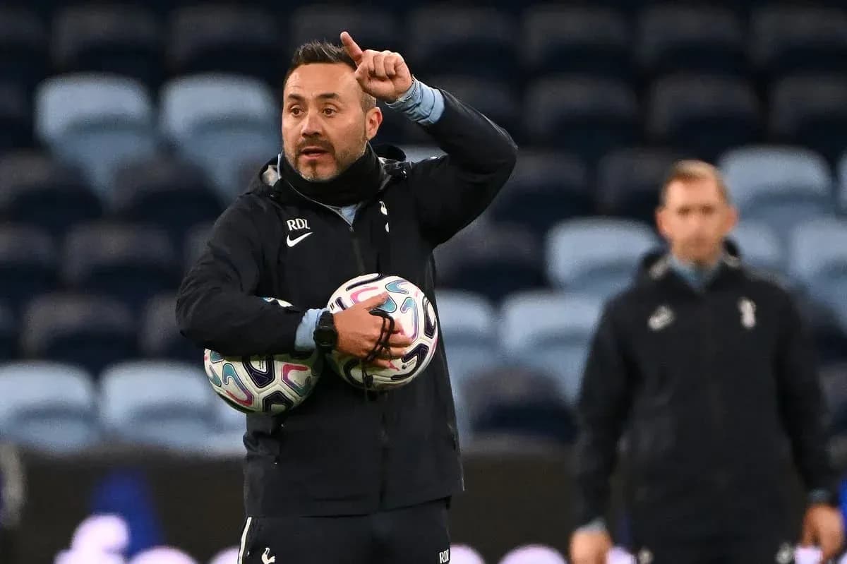 Coach giving instructions while holding soccer balls