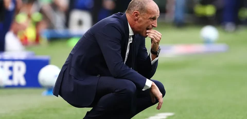 Coach crouching on sidelines during match