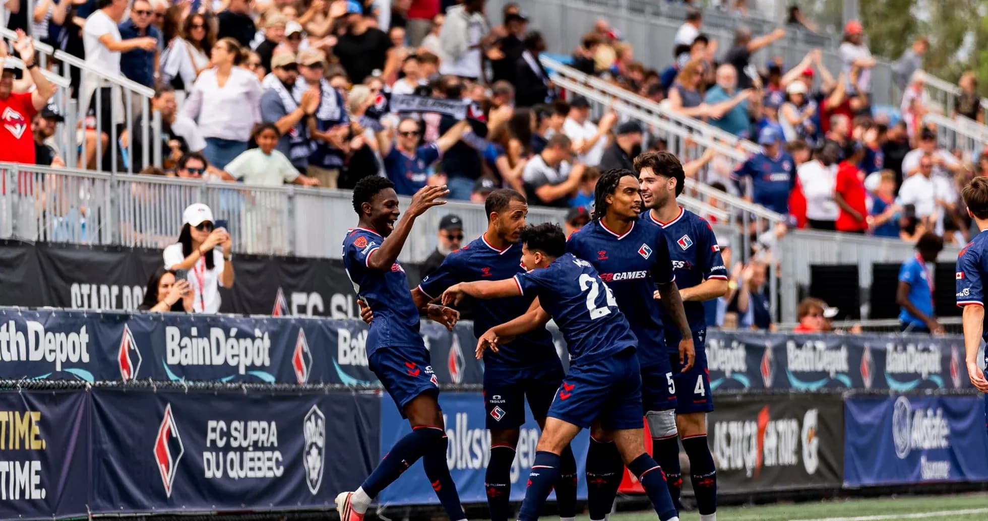 Players celebrating a goal during match