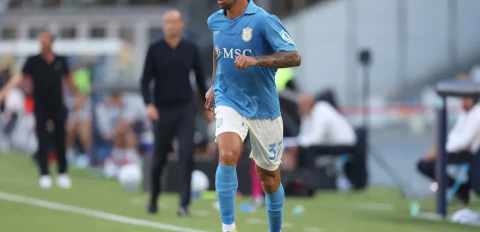 Player in blue jersey dribbling a soccer ball