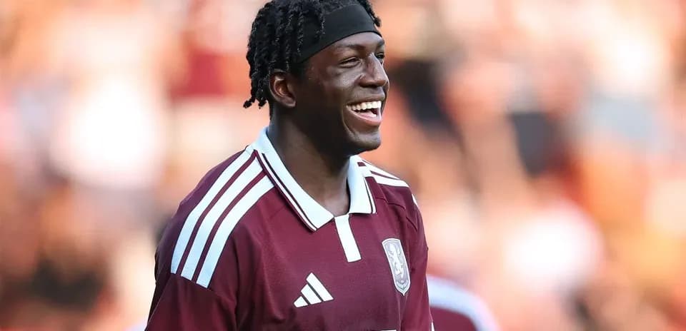 Player smiling while wearing maroon team jersey