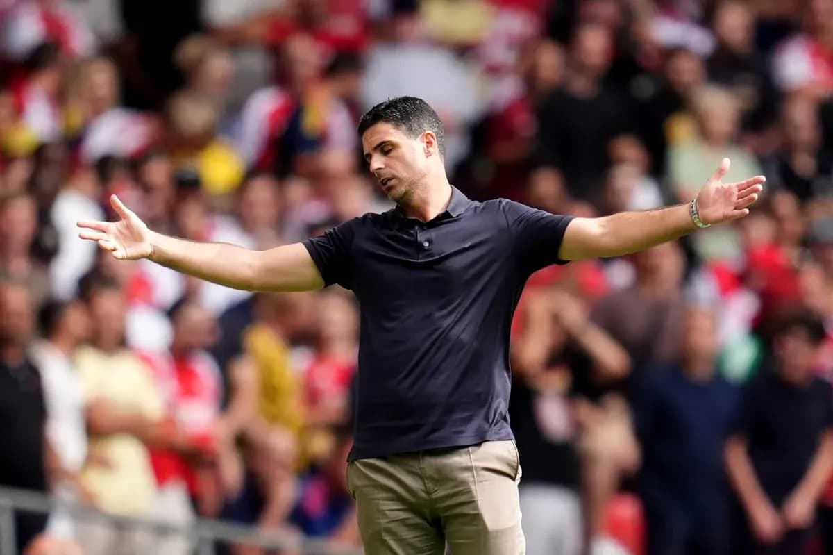 Manager gesturing during match with crowd in background