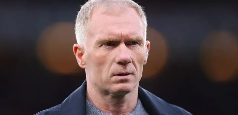 Man in a dark jacket looking intently