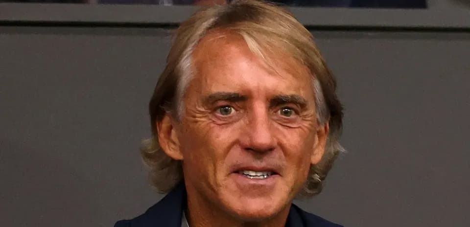 Coach sitting in stands during a match