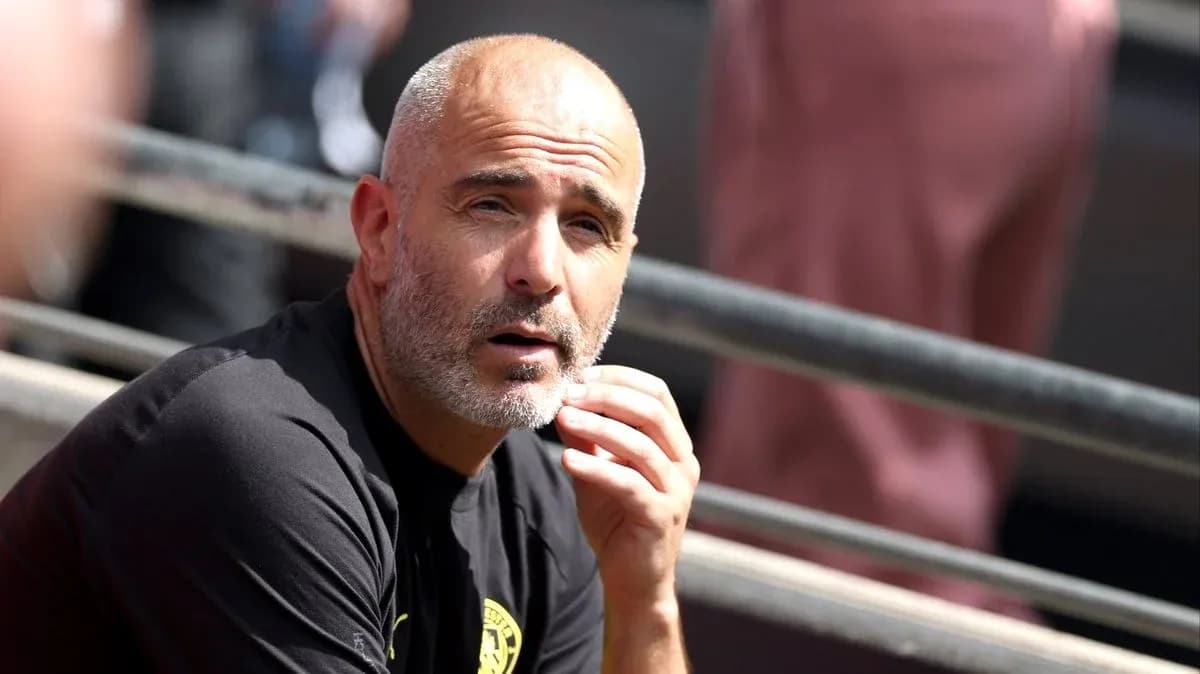 Coach sitting on bench during match