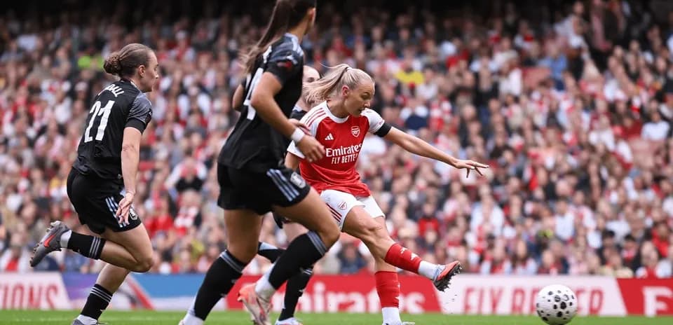 Arsenal player shooting during FA WSL match