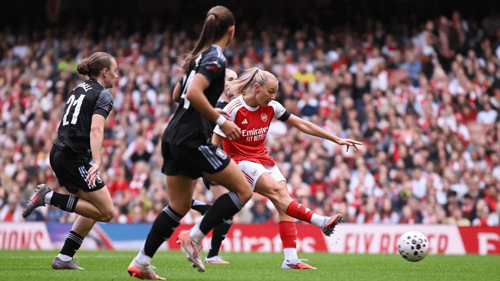 Arsenal player shooting during FA WSL match