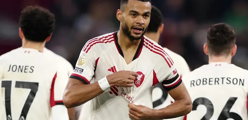 Liverpool player adjusting jersey during match