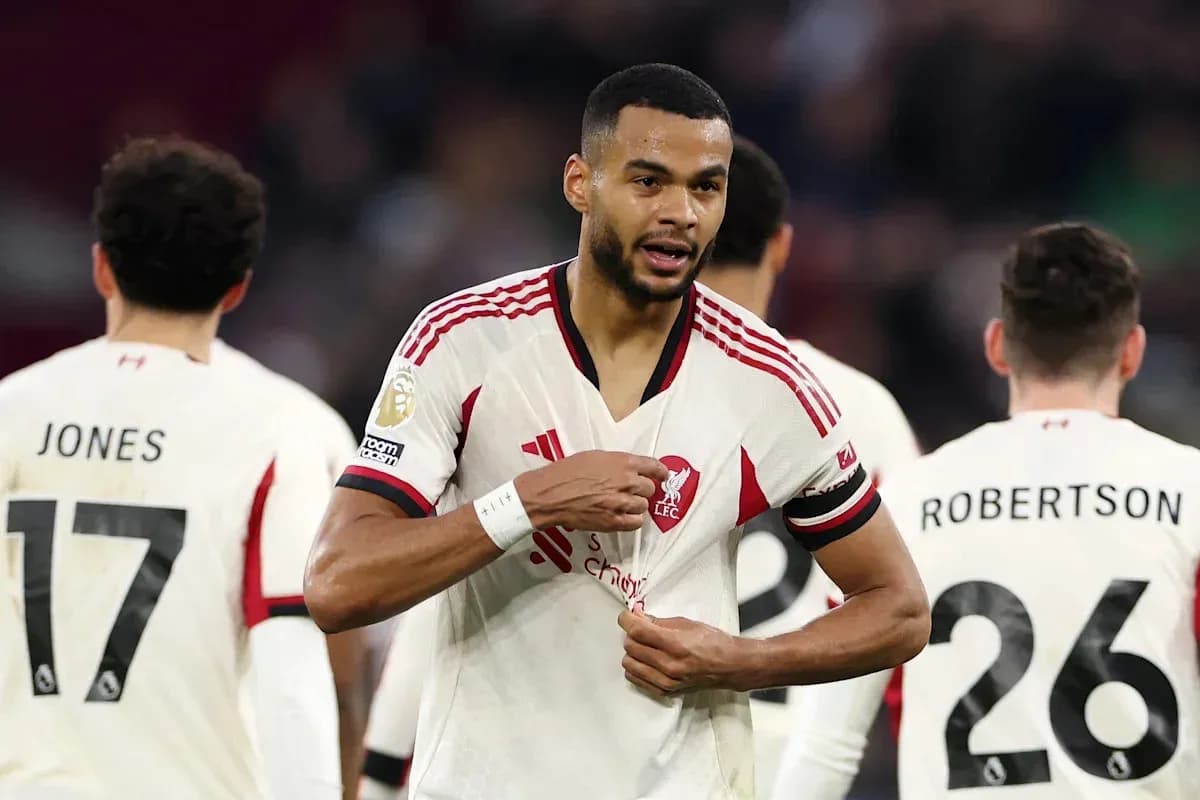 Liverpool player adjusting jersey during match