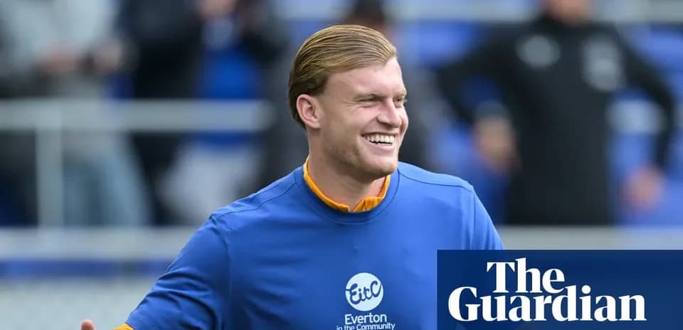 Player smiling during warm-up at Everton training session