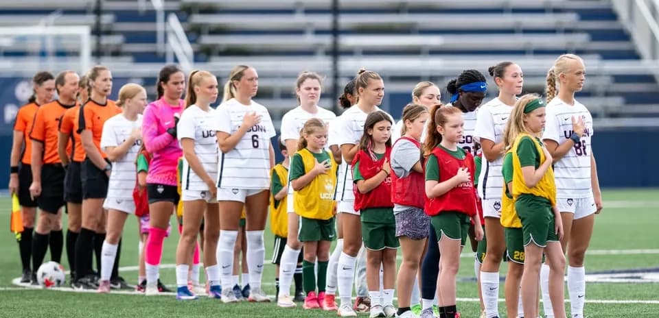 Players and referees lined up before soccer match