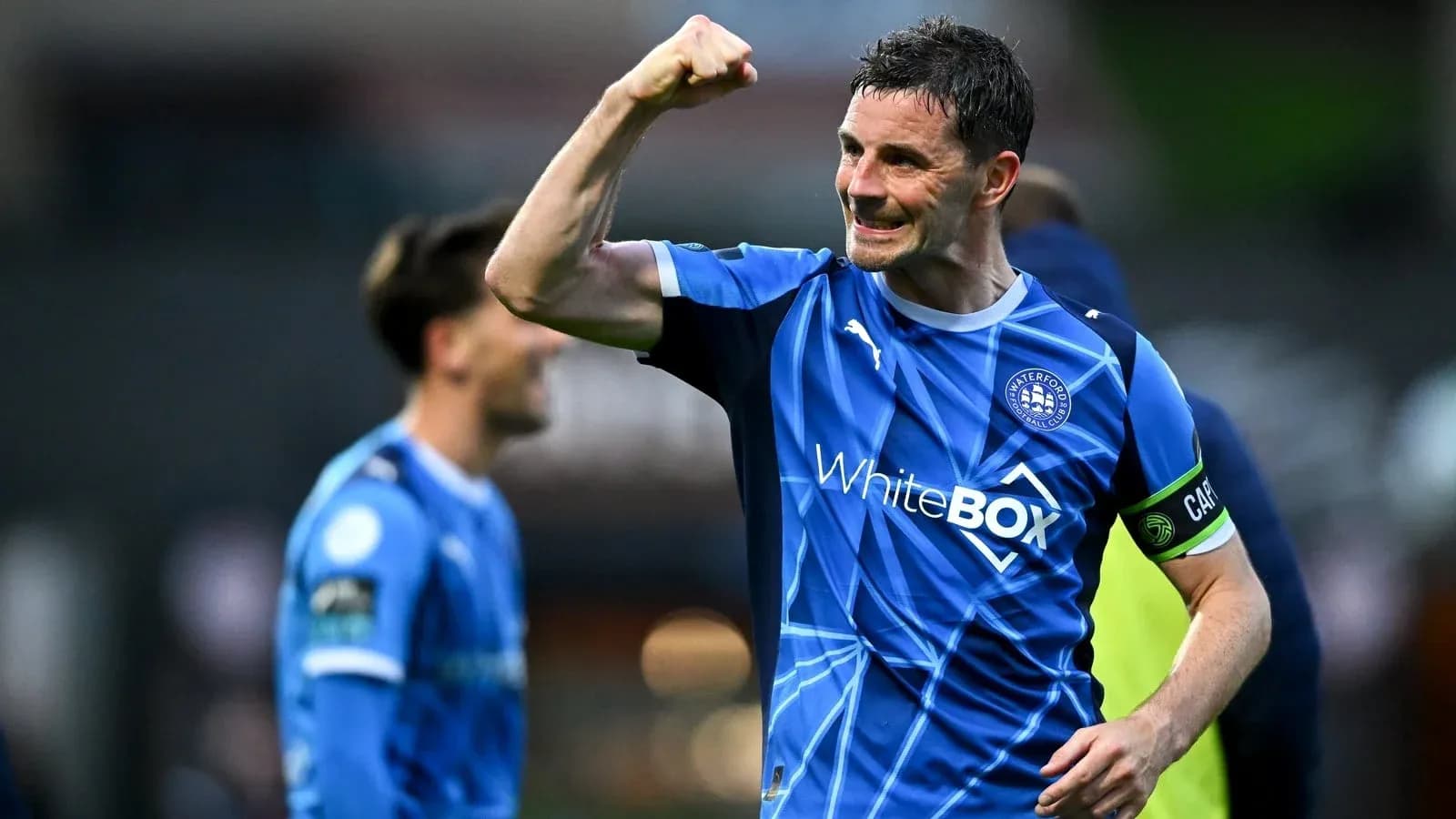 Player celebrating with a raised fist on field