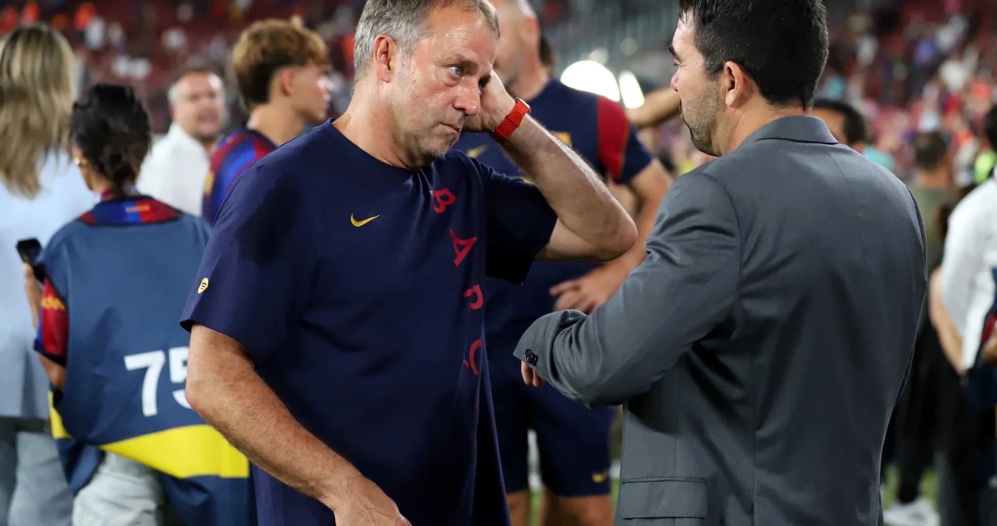 Coaches discussing after the match on the field