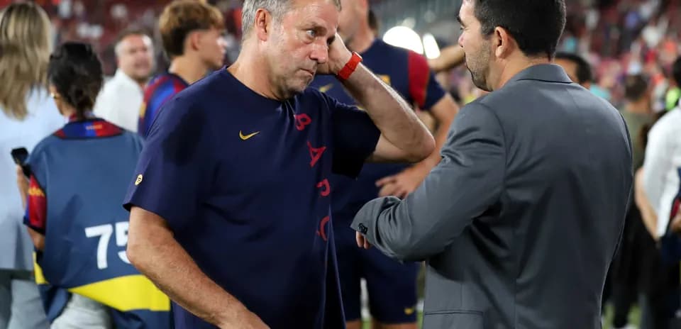 Coaches discussing after the match on the field