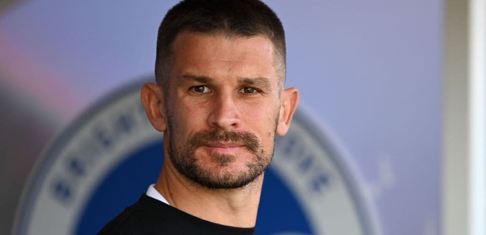 Player posing for portrait at stadium backdrop