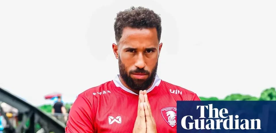 Player posing in red jersey with hands together