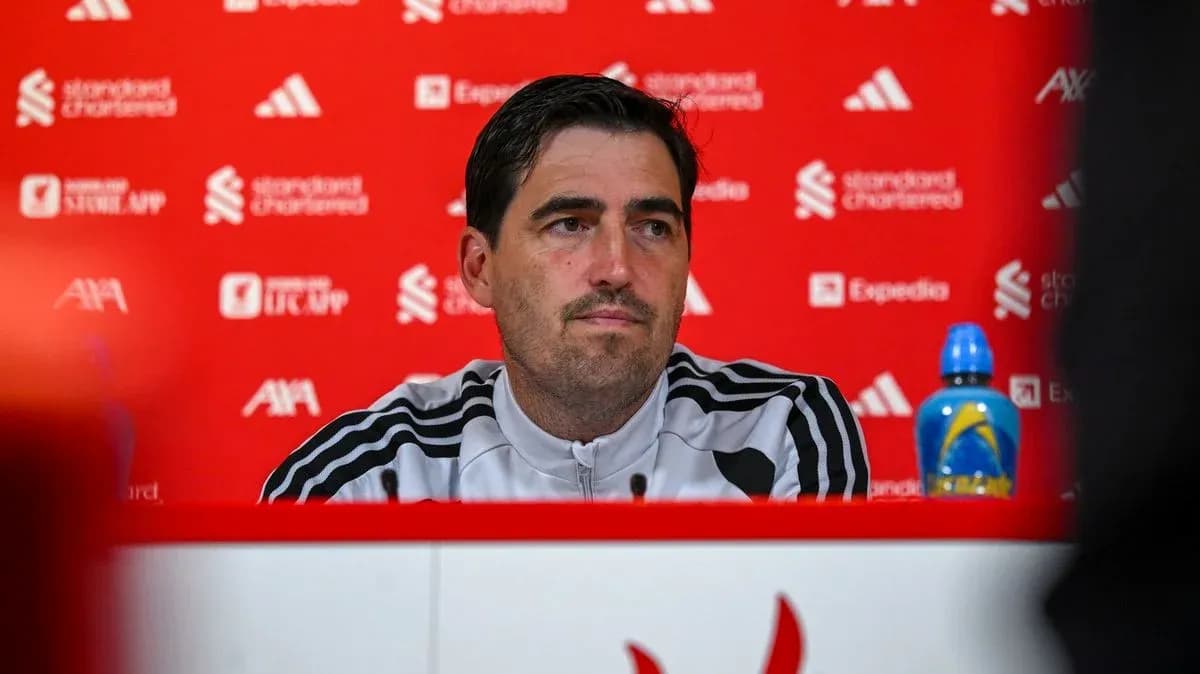 Manager at press conference with branded backdrop