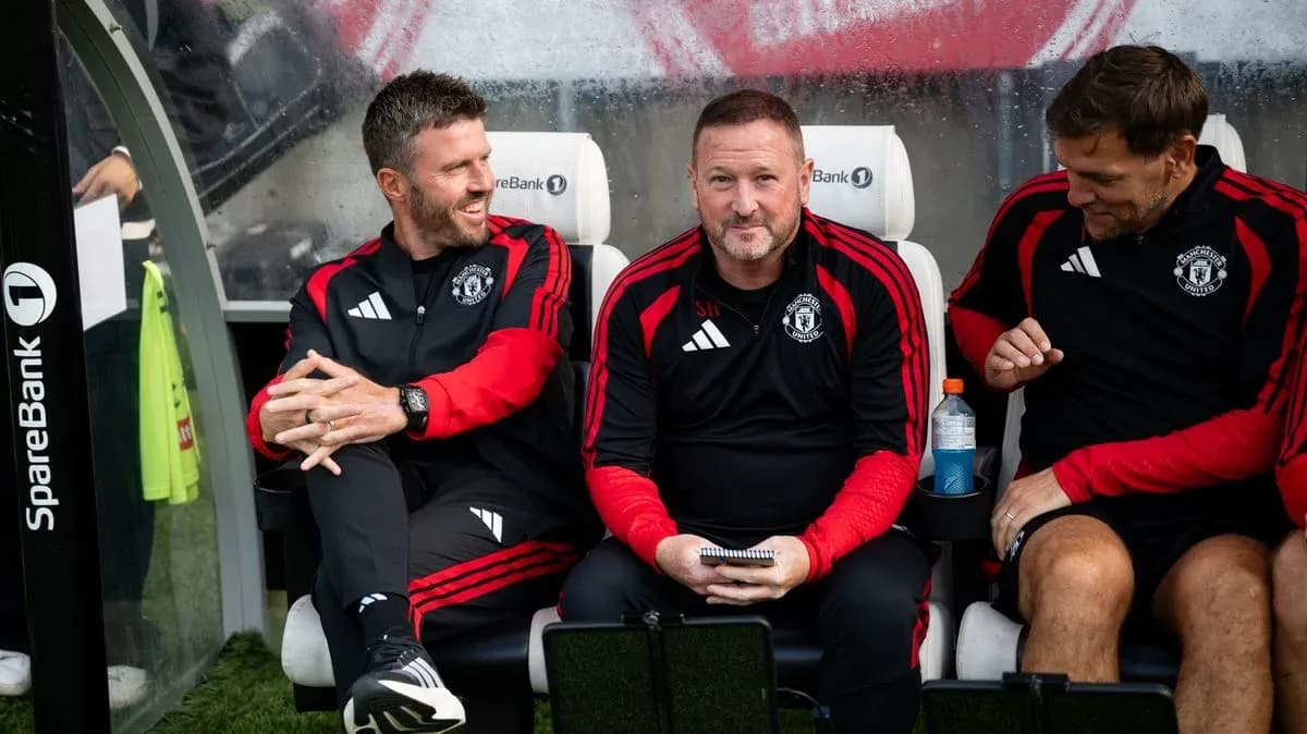 Coaching staff seated on Manchester United bench