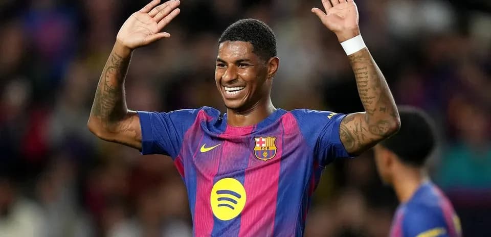 Player celebrating with hands raised on the pitch