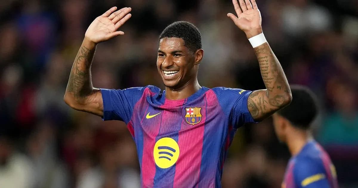 Player celebrating with hands raised on the pitch