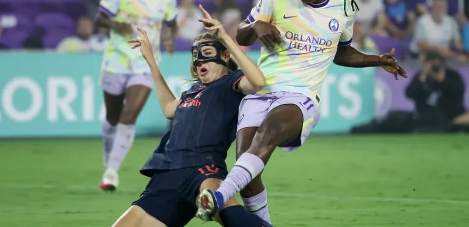 Player tackles opponent during NWSL match