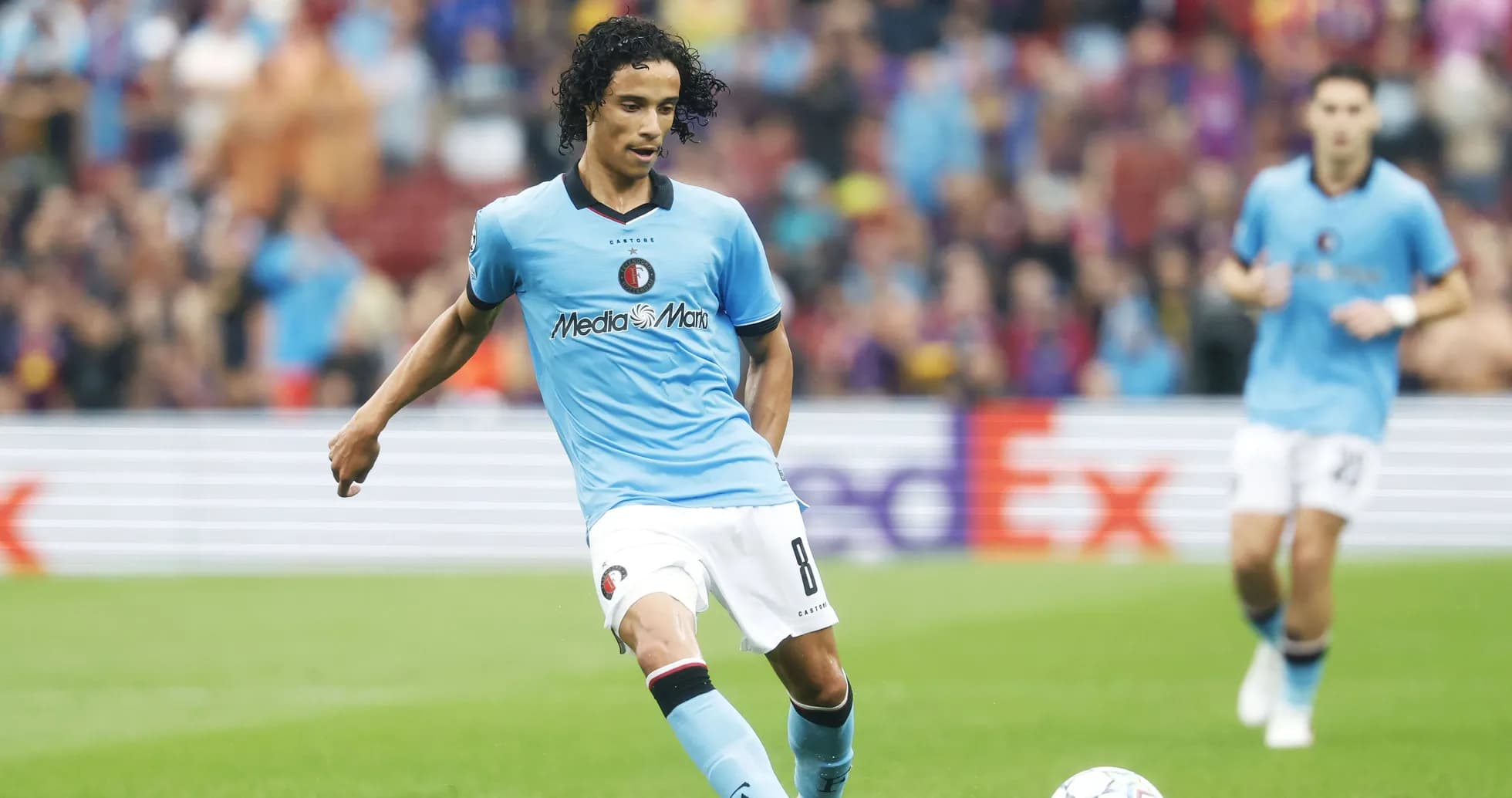 Player in blue kit preparing to kick ball