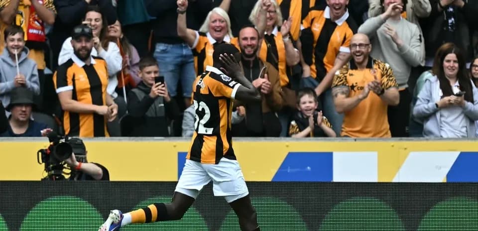 Player celebrating a goal in front of cheering fans