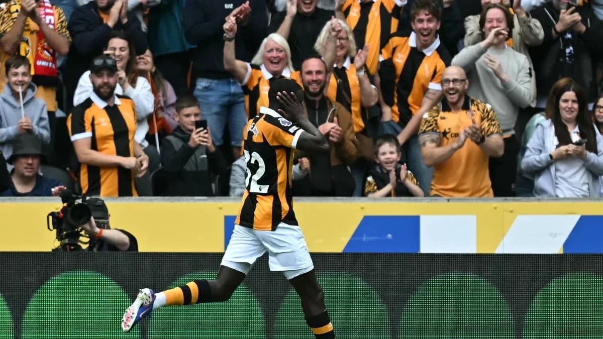 Player celebrating a goal in front of cheering fans