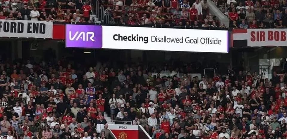 Crowd reacting to VAR decision at stadium