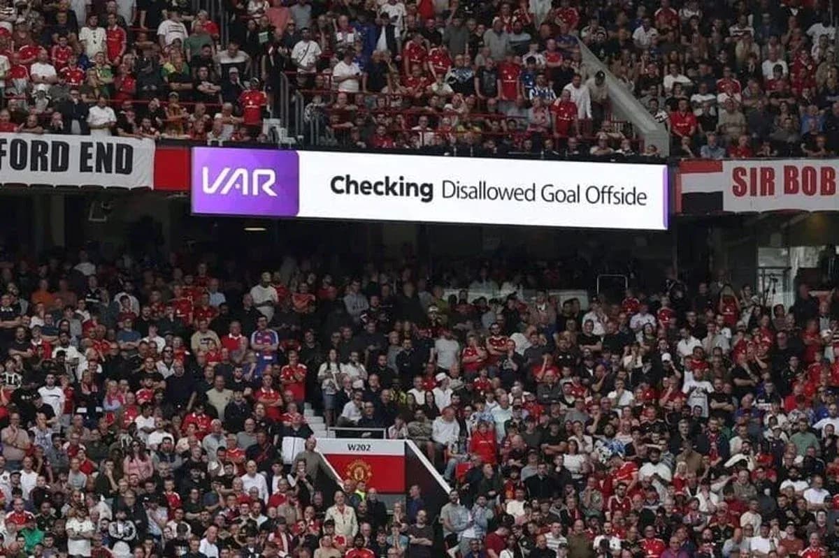 Crowd reacting to VAR decision at stadium