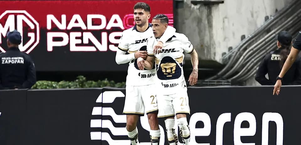 Pumas players celebrating a goal during Liga MX match