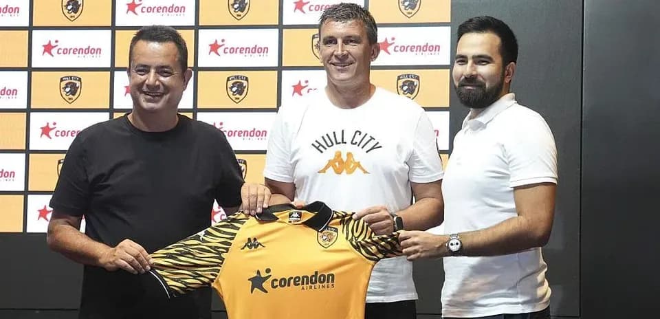 Manager holding Hull City jersey at press event