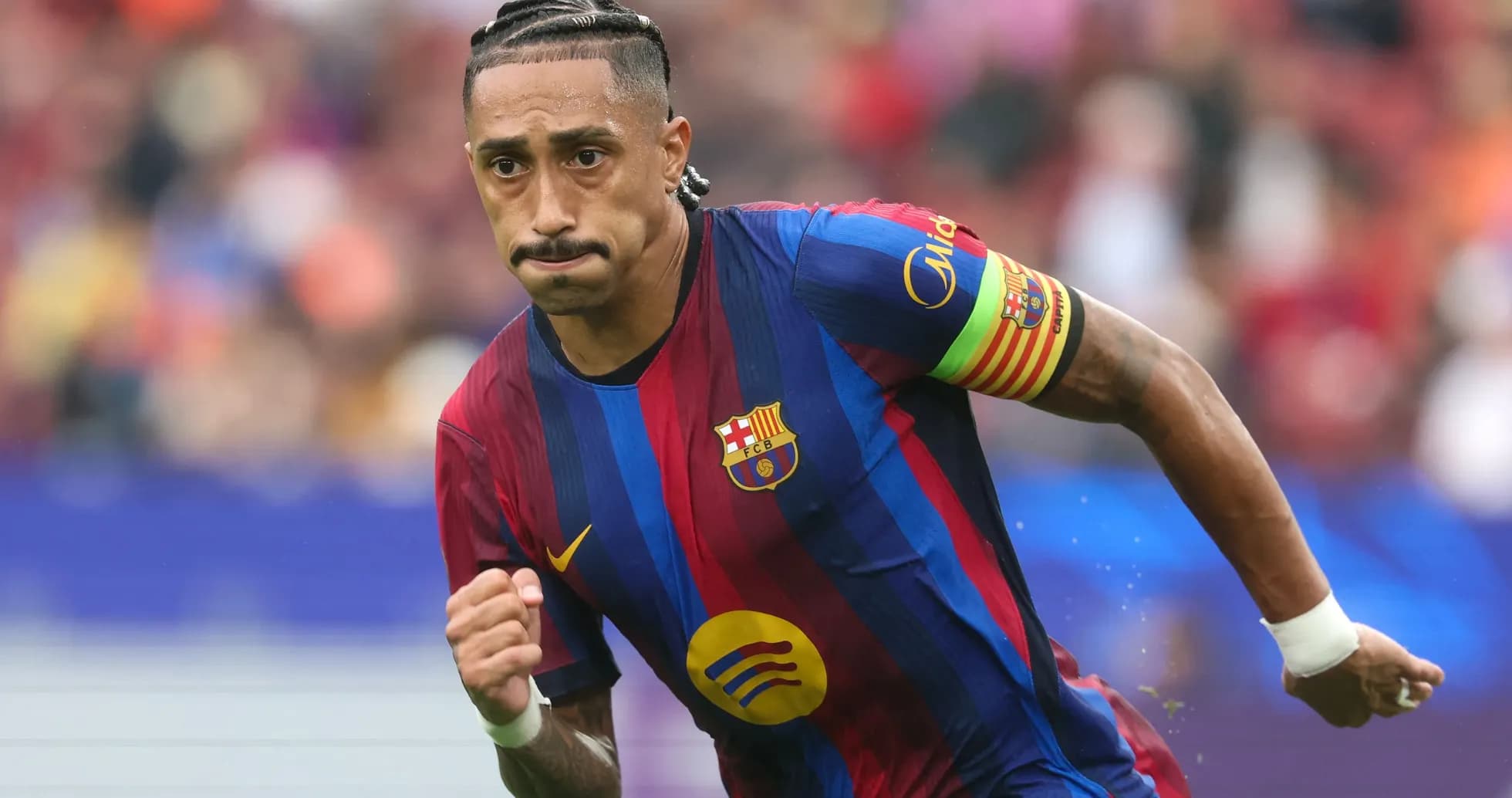 Player running with ball in FC Barcelona jersey