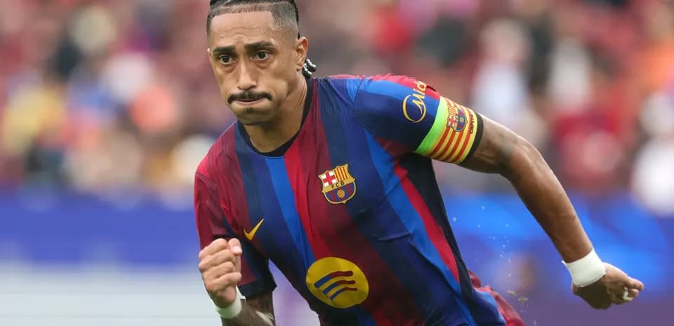 Player running with ball in FC Barcelona jersey