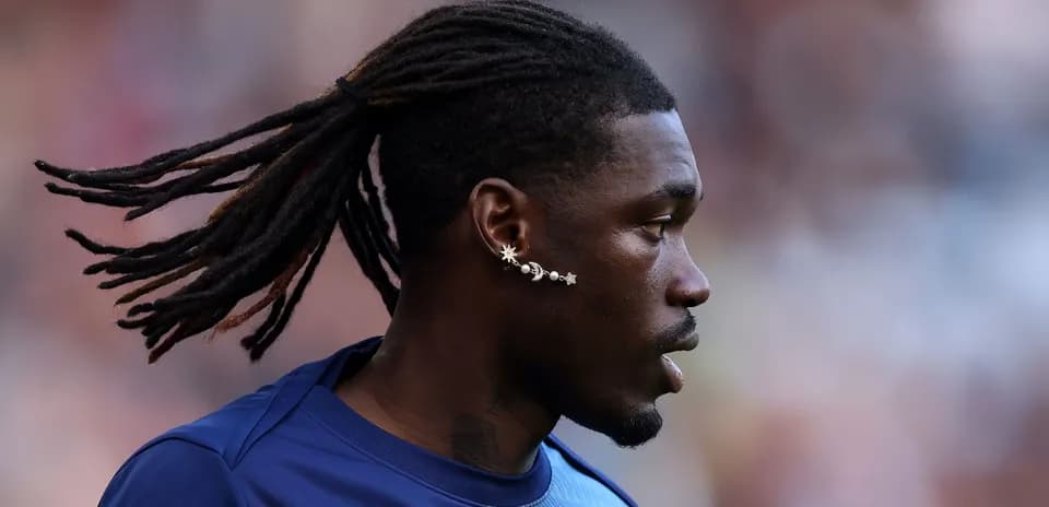 Player with long hair and unique ear jewelry