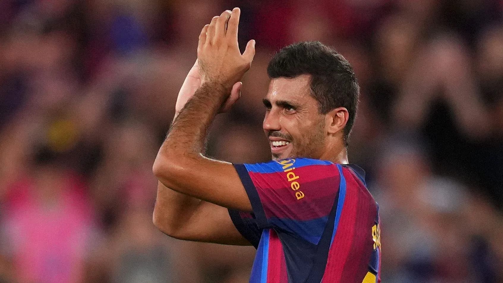 Player applauding fans during a match