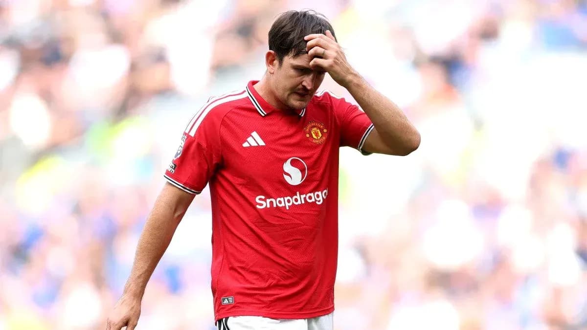 Player in red jersey walking off the pitch