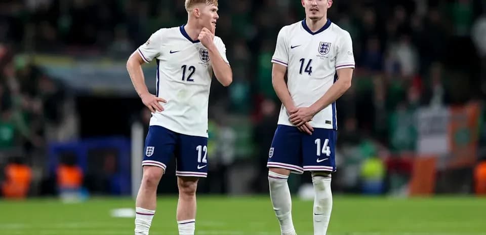 Two England players on the field after match