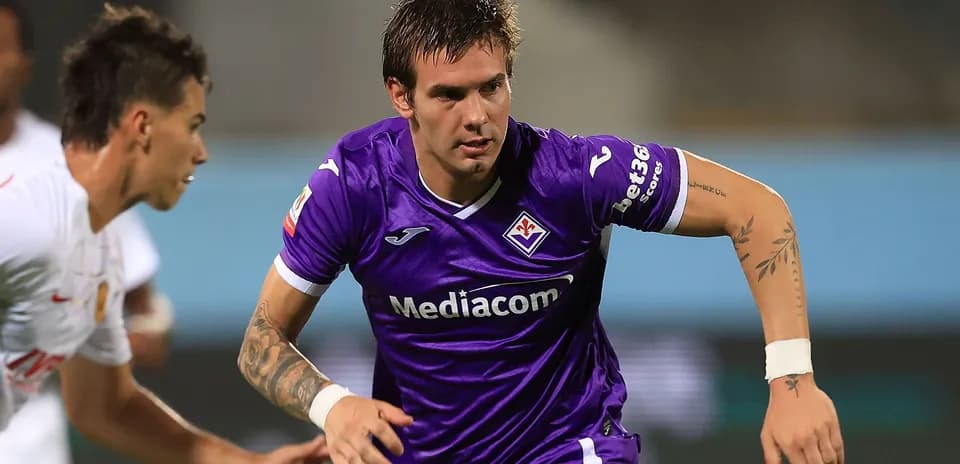 Player in purple jersey sprinting on the field