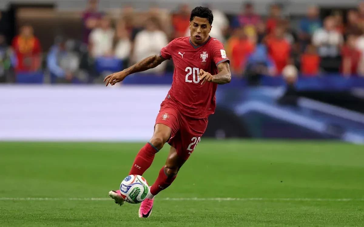 Player in red jersey running with soccer ball